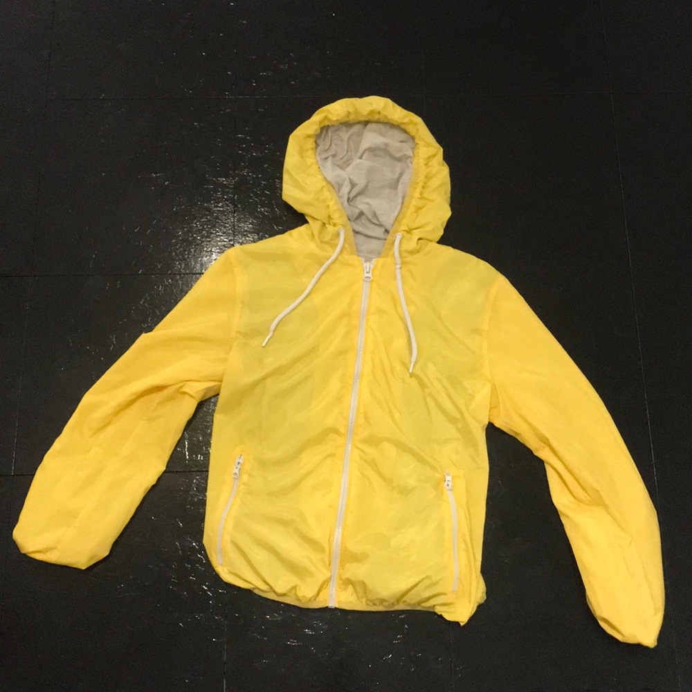 Yellow long sleeve Windbreaker with drawstrings.
